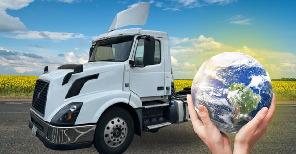 a truck in the background and a Globe in someone's hands